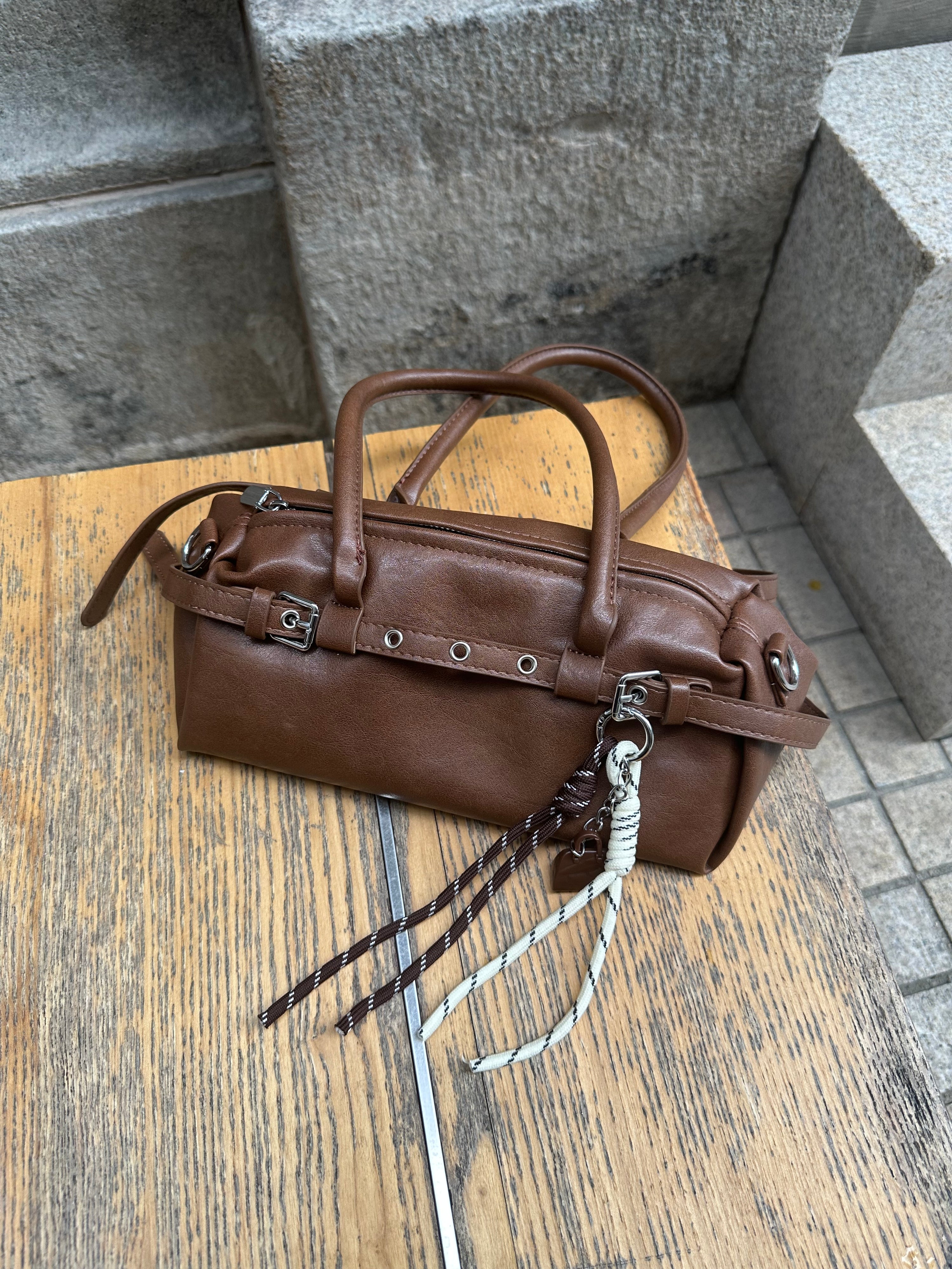 Brown Leather Buckle-Detail Handbag with Rope Charm
